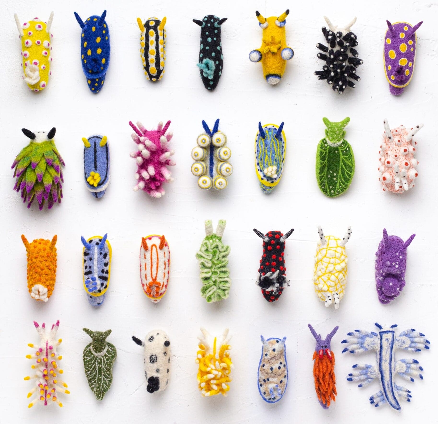 An image showing a collection of felted art pieces resembling nudibranchs